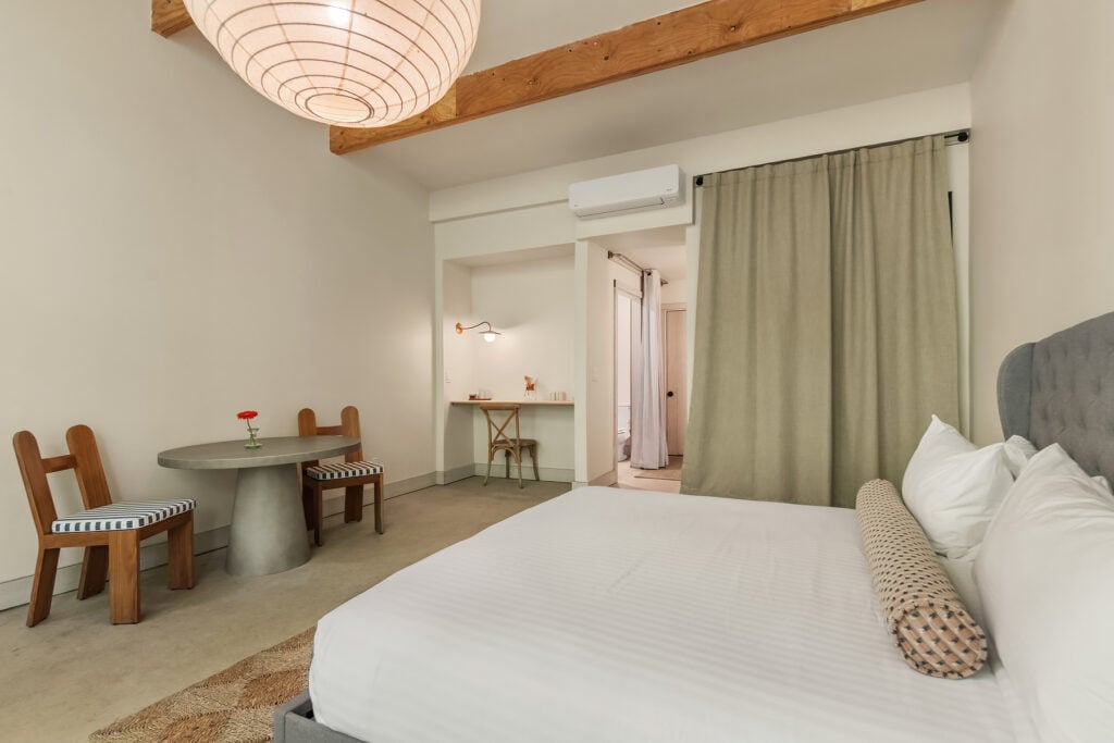 Fields Cottage - King table bed, coffee area entrance to bathroom